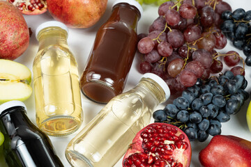 Different types of vinegar balsamic, apple, wine and pomegranate in glass bottles