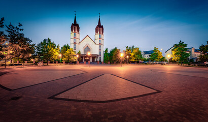 Exciting summer dawn in Plock town, Poland, Europe. Attractive morning view of  Roman Catholic Parish of St. Wojciech on square of Jana Pawła II. Traveling concept background.
