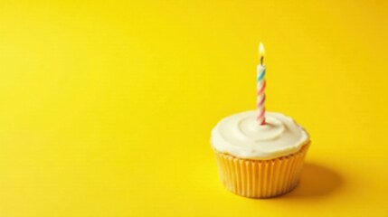 A Single Lit Candle on a Vanilla Cupcake Against a Vibrant Yellow Background