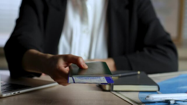 Agent giving passports and tickets to man close up. Person buying flight tickets in travel agency for summer vacation