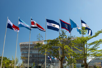 Waving flags of the seven Central American countries - Belize, Costa Rica, El Salvador, Guatemala, Honduras, Nicaragua, and Panama at  Jardin Centroamerica in downtown of San Salvador, El Salvador.