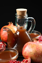 Natural Traditional Pomegranate Vinegar in Vinegar Cruet on Black Background