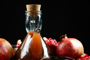 Natural Traditional Pomegranate Vinegar in Vinegar Cruet on Black Background