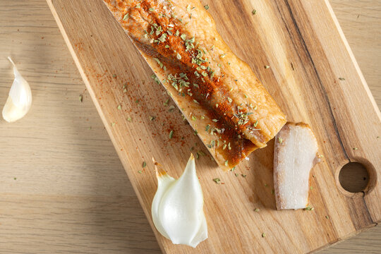 Piece of cured pork belly, a traditional Romanian delicacy called "slanina" with onion and garlic.