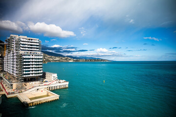 New buildings construction in the sea of Monaco, over blue sea and sky