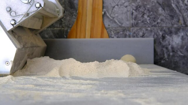 Phyllo bread, hands making phyllo bread dough maker close-up