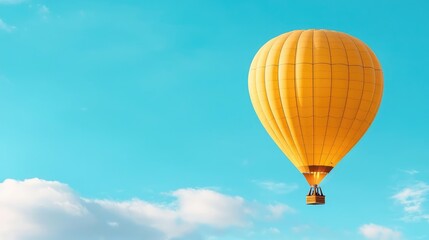 Naklejka premium Yellow hot air balloon soaring, clear sky, clouds, travel adventure