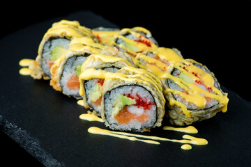 Set of sushi rolls on a black matte plate.
Sushi set on a black matte plate.
Japanese traditional sushi dish. A beautiful dish for an Asian restaurant menu.