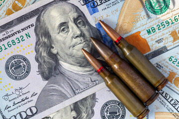 Background with American dollars and bullets from a machine gun. Global world crisis and world war