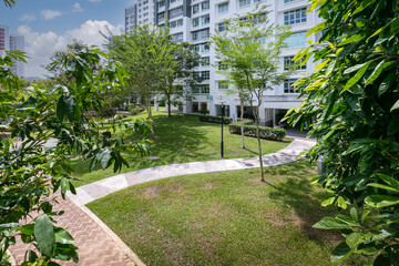 A garden path in a green landscape within an HDB estate in Keat Hong, Singapore. 