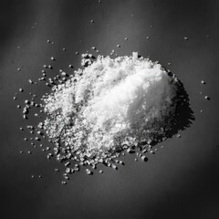 Black and white photography, extreme close-up, coarse salt crystals, rough wooden surface, grainy texture, shallow depth of field, monochromatic, high contrast, culinary still life, minimalist composi
