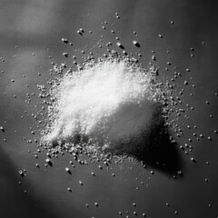 Black and white photography, extreme close-up, coarse salt crystals, rough wooden surface, grainy texture, shallow depth of field, monochromatic, high contrast, culinary still life, minimalist composi