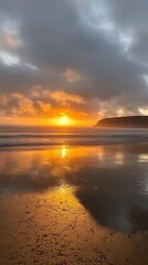 Obraz premium Vibrant sunset over calm ocean reflecting on wet sand.