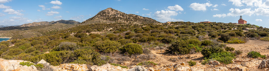 Landscape of the hinterland of Sardinia with the red lighthouse of Capo Spargivento
