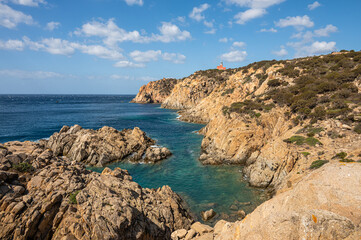 The beautiful Capo Spargivento in southern Sardinia with the red lighthouse dominating it from above