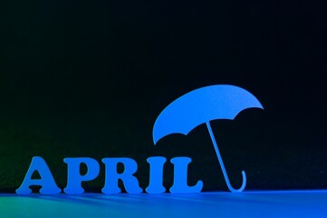 Blue April with umbrella on a black background