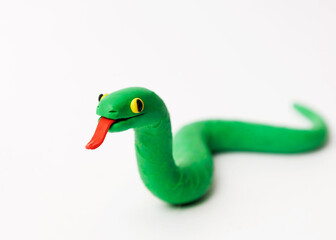 Fototapeta premium green plasticine snake on white background