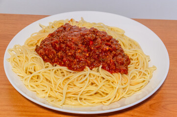 Plate with spaghetti pasta with bolognese sauce with parmesan.