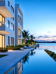 Fototapeta premium Waterfront Luxury Apartments - Modern apartments with infinity pool overlooking a tranquil waterfront at sunset. Luxurious living space with stunning views.