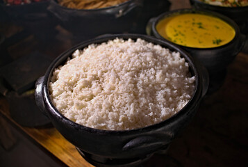 White rice cooked in a clay pot. Rice has nutrients such as fiber and vitamins and plenty of carbohydrates. A container containing cooked white rice ready to eat.