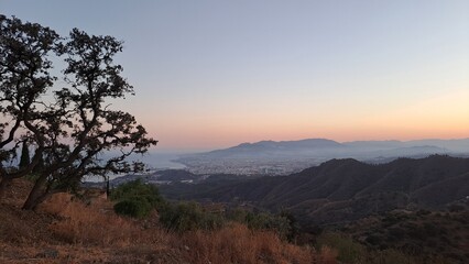 Obraz premium A serene sunset over Andalusian hills, where golden light meets the fading earth. A timeless blend of nature's resilience and tranquil beauty, perfect for travel and landscape inspiration