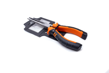 Needle nose pliers with black and orange handles on white background