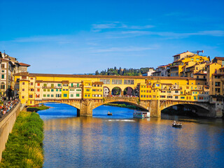 Ponte Vecchio bridge over Arno River in Florence. Picturesque medieval arched river bridge with Roman origins, lined with jewelry and souvenir shops.
