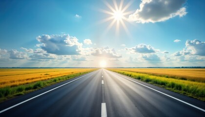 Naklejka premium Empty asphalt road stretches into golden field under sunny sky. Beautiful landscape photo shows wide road with vibrant yellow fields on both sides. Travel destination business concept image. Perfect