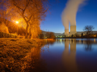 Nuclear power plant. View of cooling towers and water vapour. Production of electricity. Science...