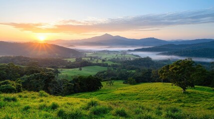 Obraz premium Sunrise over misty valley, green hills, scenic landscape, idyllic rural view, travel photography