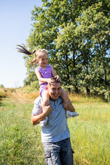 Obraz premium Dad and daughter having fun. Family in the park. Family having fun. Daughter. Happy family. 