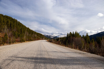 Road in Canada with mountain in the distance