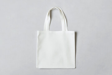 White tote bag mockup on a grey background. 
