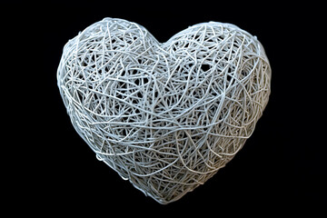 Intricate white threads woven into a heart shape.