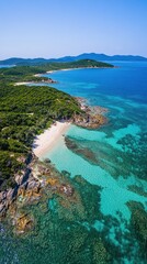 Aerial view of a serene beach with clear turquoise waters and lush green coastline.
