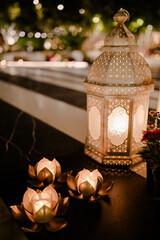 Romantic evening scene with lit candles and an ornate lantern.