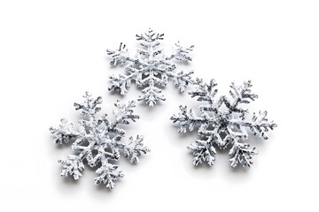 Detailed photo of three snowflakes isolated on a white background, realistic and high-definition.