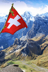 Flag of Switzerland in front of a beautiful mountain panorama