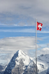 Flag of Switzerland in front of a beautiful mountain panorama