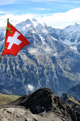 Flag of Switzerland in front of a beautiful mountain panorama
