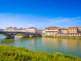 Fototapeta premium Ponte alla Carraia bridge and the historic old town houses over River Arno in Florence, Italy