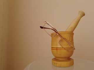 Antique mortar for grinding grain with glasses.