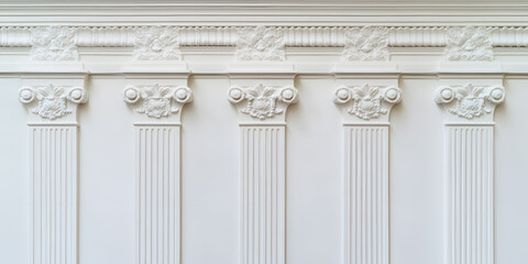 Obraz premium Elegant white wall with ornate pillars and molding. Classic architectural detail perfect for design projects or backgrounds.