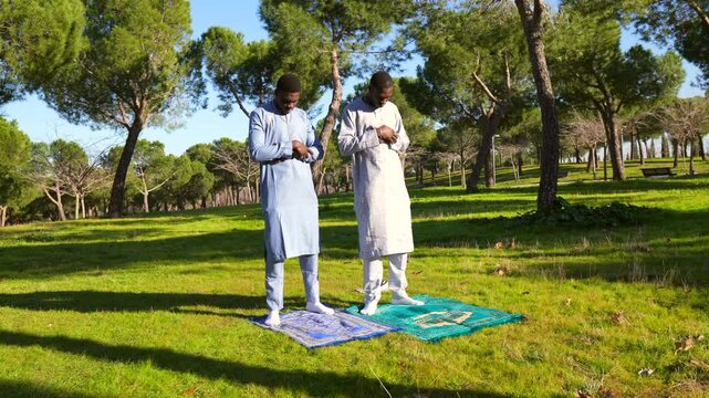 Senegalese men praying in park during ramadan