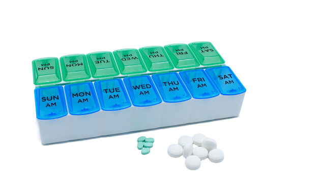 Weekly 2 X Twice a Day AM and PM Pill tablet Organizer Blue and green color,  plastic container to help keep track of prescription medications needed for a healthy life.  Isolated on white background