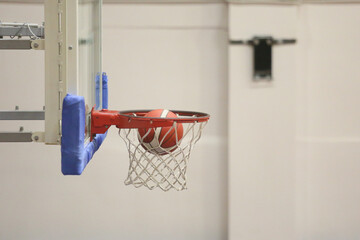 A basketball going into the hoop during a game
