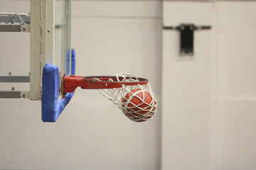 A basketball going into the hoop during a game