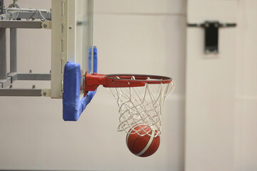 A basketball going into the hoop during a game
