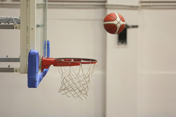 A basketball going into the hoop during a game