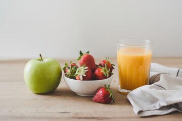 Healthy Breakfast: Juicy Orange Juice, Green Apple, and Fresh Strawberries